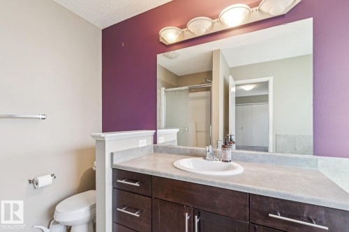 Dark wood-finish vanity with an integrated sink and light-toned countertop - 12007 173 Avenue Nw, Edmonton, AB 