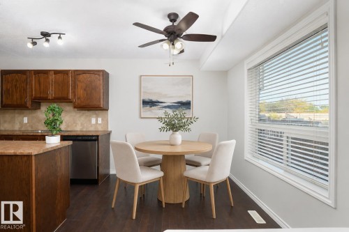 Dark wood-finish flooring with light wall tones - 441 Songhurst Place, Leduc, AB 