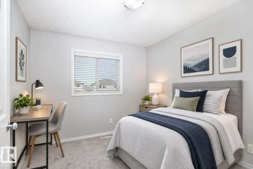 Plush carpet flooring, neutral wall tones, window with horizontal blinds, overhead flush mount lighting, and a built-in closet with a white panel door - 441 Songhurst Place, Leduc, AB 