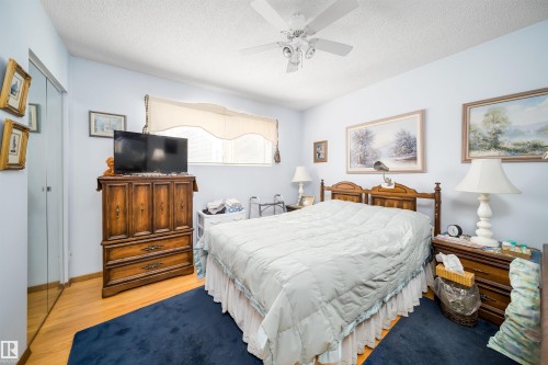 Wood-finish flooring with a ceiling fan overhead - 4808 106 Avenue Nw, Edmonton, AB 