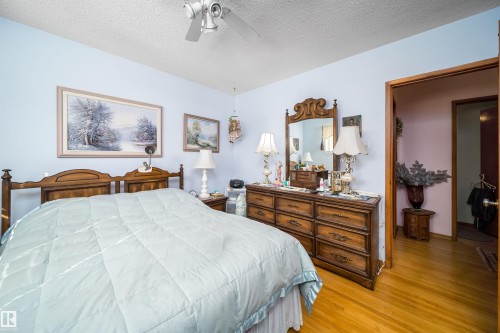 Wood-finish flooring with a ceiling fan light fixture - 4808 106 Avenue Nw, Edmonton, AB 
