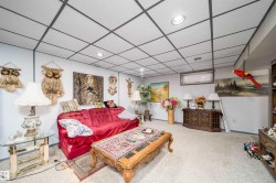 Recessed lighting with a drop ceiling grid, built-in shelving, and a small window - 
