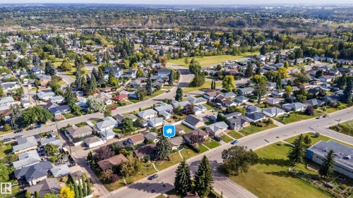 Residential neighborhood featuring paved streets, mature trees, and a mix of single-story and two-story homes - 4808 106 Avenue Nw, Edmonton, AB 