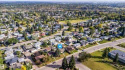 Residential neighborhood featuring paved streets, mature trees, and a mix of single-story and two-story homes - 