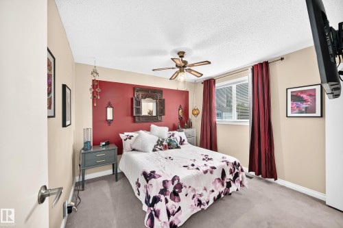 Recessed ceiling fan, neutral carpet flooring, single window with white frame, two-tone wall treatment, and built-in closet - 5620 93A Avenue Nw, Edmonton, AB 