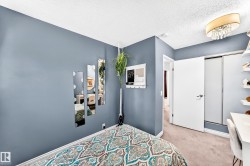 Wall-to-wall carpeting with light-toned walls, featuring a sliding closet door and a white paneled interior door - 