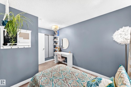 Built-in shelving, sliding closet doors, and recessed ceiling lighting with a decorative fixture - 5620 93A Avenue Nw, Edmonton, AB 