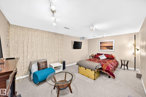 Carpeted flooring, recessed lighting, and wall-mounted television - 5620 93A Avenue Nw, Edmonton, AB 