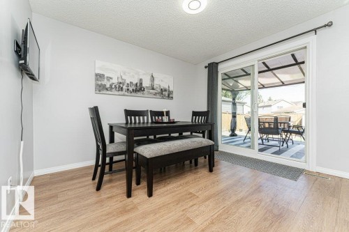 Wood-finish flooring, sliding glass patio door, and recessed lighting - 6 Kiniski Crescent Nw, Edmonton, AB 