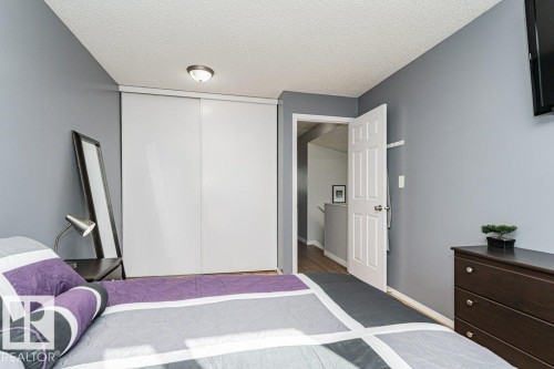 Sliding panel closet doors, neutral wall paint, and overhead flush-mount lighting - 6 Kiniski Crescent Nw, Edmonton, AB 