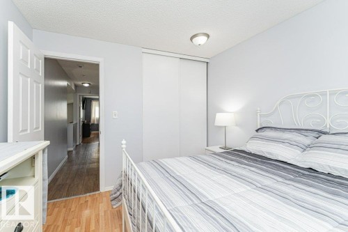 Recessed ceiling light fixture, sliding closet doors, wood-finish flooring, white paneled door - 6 Kiniski Crescent Nw, Edmonton, AB 