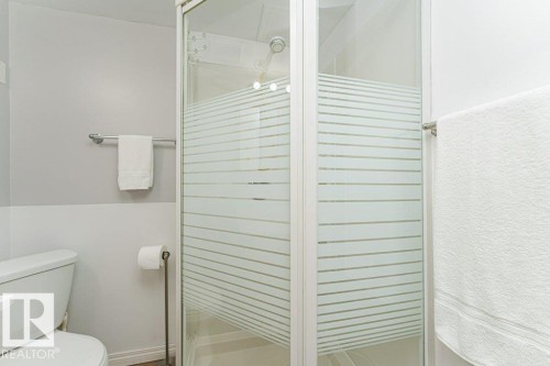 Shower enclosure with frosted glass panels, white shower base, and integrated shower head - 6 Kiniski Crescent Nw, Edmonton, AB 