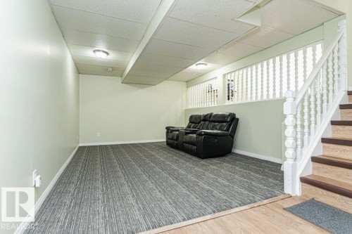 Recessed lighting, wood-finish flooring, staircase with white balusters, and a suspended ceiling - 6 Kiniski Crescent Nw, Edmonton, AB 