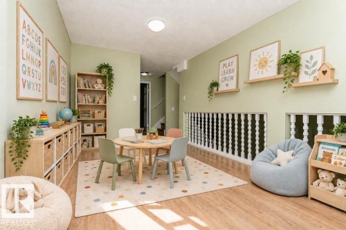 Wood-finish flooring, light green walls, built-in shelving, white spindle railing, and recessed lighting - 6 Kiniski Crescent Nw, Edmonton, AB 