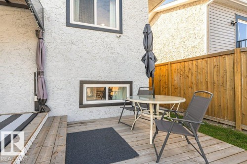 Wood-finish deck with a privacy fence and stucco exterior - 6 Kiniski Crescent Nw, Edmonton, AB 