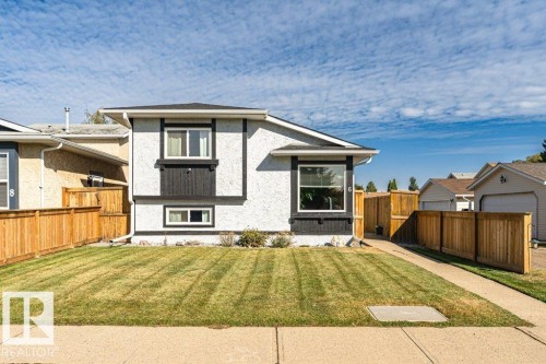 Stucco exterior with contrasting trim, multiple windows, and a paved walkway - 6 Kiniski Crescent Nw, Edmonton, AB 