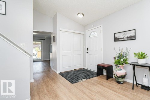 Light wood-finish flooring, white paneled doors, and a vaulted ceiling - 6 Kiniski Crescent Nw, Edmonton, AB 