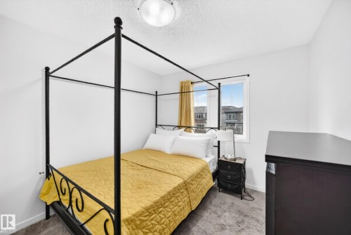 Bedroom featuring a single window, carpeted flooring, and a ceiling-mounted light fixture - 19716 27 Avenue Nw, Edmonton, AB - Indoor Photo Showing Bedroom