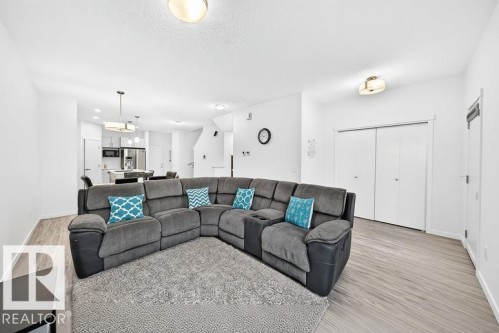 Open-concept living space featuring wood-finish flooring, recessed lighting, and a white color palette - 19716 27 Avenue Nw, Edmonton, AB - Indoor Photo Showing Living Room