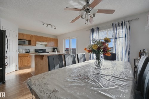 Open-concept design featuring wood-finish flooring - 15911 38 Street Nw, Edmonton, AB 