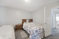 Gray carpeting, neutral wall paint, and a built-in overhead light fixture - 