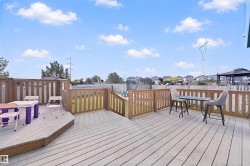 Expansive backyard deck with wood-finish flooring and full perimeter fencing - 
