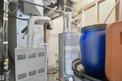 Mechanical room featuring a water heater and furnace - 15911 38 Street Nw, Edmonton, AB 