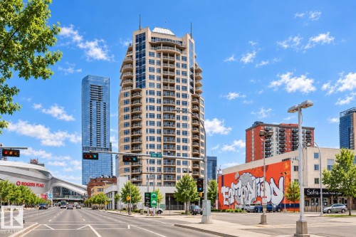 High-rise building with numerous private balconies, a glass exterior, and a prominent rooftop architectural feature - #1902 10388 105 St Nw, Edmonton, AB 