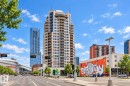 High-rise building with numerous private balconies, a glass exterior, and a prominent rooftop architectural feature - #1902 10388 105 St Nw, Edmonton, AB 