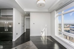 Wide plank wood-finish flooring, white trim, recessed lighting, and a modern ceiling fixture - 