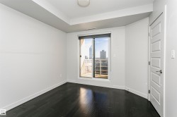 Wood-finish flooring, sliding glass door with balcony access, recessed ceiling, and panel door - 