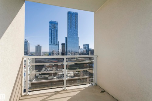 Balcony with a glass panel railing, offering expansive urban scenery - #1902 10388 105 St Nw, Edmonton, AB 