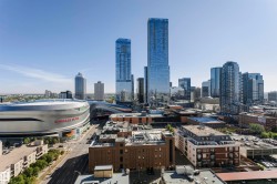 City skyline with a prominent arena and multiple high-rise structures - 
