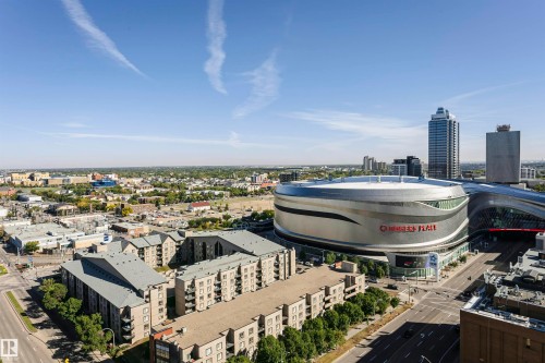 Urban landscape featuring a prominent sports arena and surrounding buildings - #1902 10388 105 St Nw, Edmonton, AB 