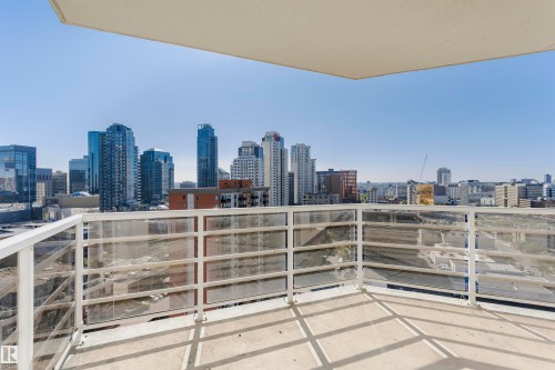 Balcony with concrete flooring and a modern railing system, showcasing an urban backdrop of multiple high-rise structures - #1902 10388 105 St Nw, Edmonton, AB 