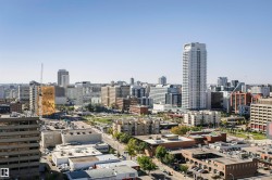 Expansive cityscape with a diverse architectural landscape, featuring high-rise structures and urban green spaces - 