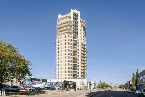 Modern high-rise residential building featuring multiple balconies, a light-colored facade, and extensive window lines - #1902 10388 105 St Nw, Edmonton, AB 