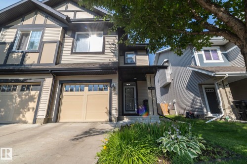 Two-story residence featuring light-colored siding with dark trim accents - 1640 Chapman Way Sw, Edmonton, AB - Outdoor With Facade