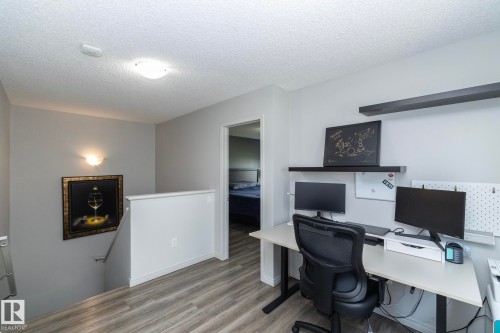 Dedicated workspace featuring wood-finish flooring, light gray walls, and recessed lighting - 1640 Chapman Way Sw, Edmonton, AB - Indoor Photo Showing Office