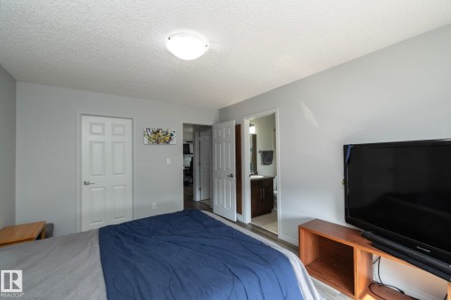 Bedroom featuring light gray walls, white six-panel doors, and a ceiling-mounted light fixture - 1640 Chapman Way Sw, Edmonton, AB - Indoor Photo Showing Bedroom
