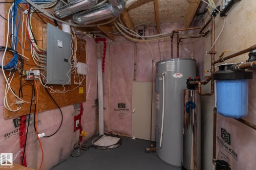 Utility room featuring a water heater, water filtration system, and electrical panel - 1640 Chapman Way Sw, Edmonton, AB - Indoor Photo Showing Basement