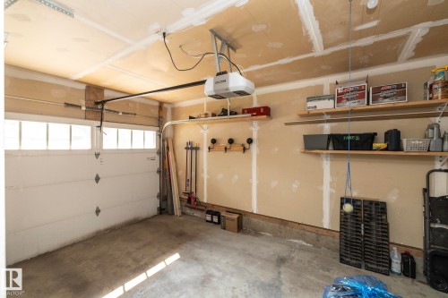 Single-car garage with a concrete floor and an automatic overhead door - 1640 Chapman Way Sw, Edmonton, AB - Indoor Photo Showing Garage