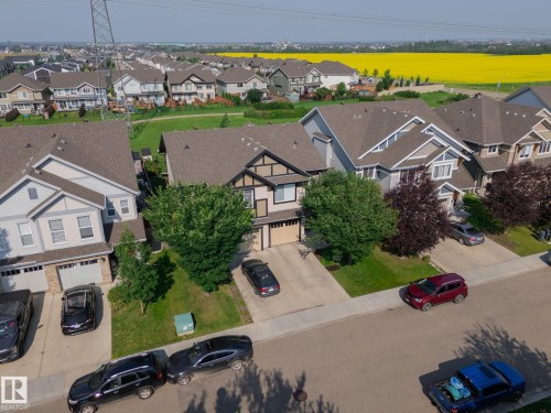 Residential street featuring multiple properties with attached garages - 1640 Chapman Way Sw, Edmonton, AB - Outdoor