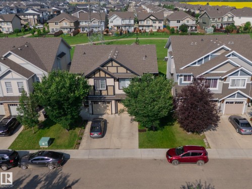 Tudor Revival-style home featuring a prominent front gable, integrated single-car garage, and a concrete driveway - 1640 Chapman Way Sw, Edmonton, AB - Outdoor With Facade