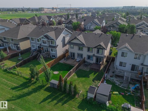 Two-story residential property with a multi-level deck, fenced backyard, and a manicured lawn - 1640 Chapman Way Sw, Edmonton, AB - Outdoor