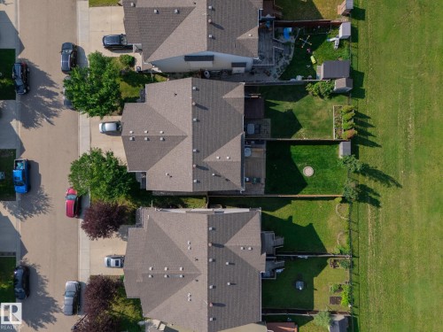 Residential street featuring multiple properties with shingled roofs and private backyards - 1640 Chapman Way Sw, Edmonton, AB - Outdoor With View