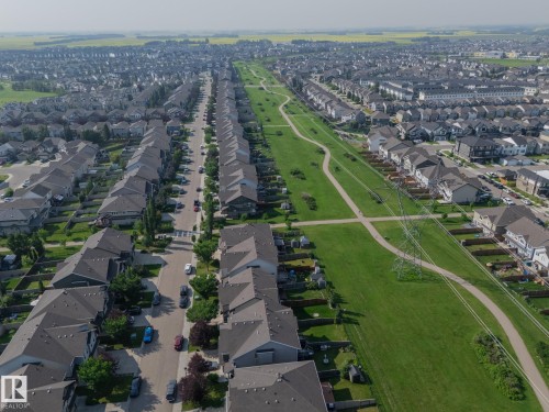 Expansive residential development featuring numerous single-family homes with gray roofs - 1640 Chapman Way Sw, Edmonton, AB - Outdoor With View