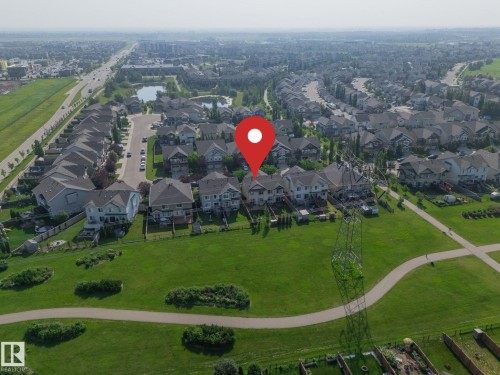 Residential property with a manicured lawn backing onto a green space - 1640 Chapman Way Sw, Edmonton, AB - Outdoor With View