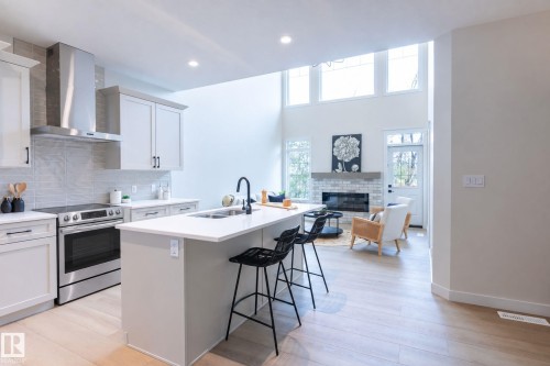 Open-concept living space with high ceilings and transom windows - 6306 65 Ave, Beaumont, AB 