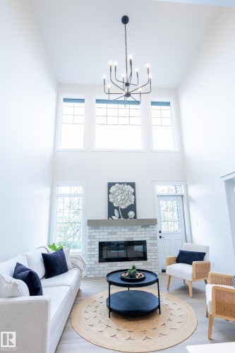 Double-height ceiling with a multi-pane window array - 6306 65 Ave, Beaumont, AB 